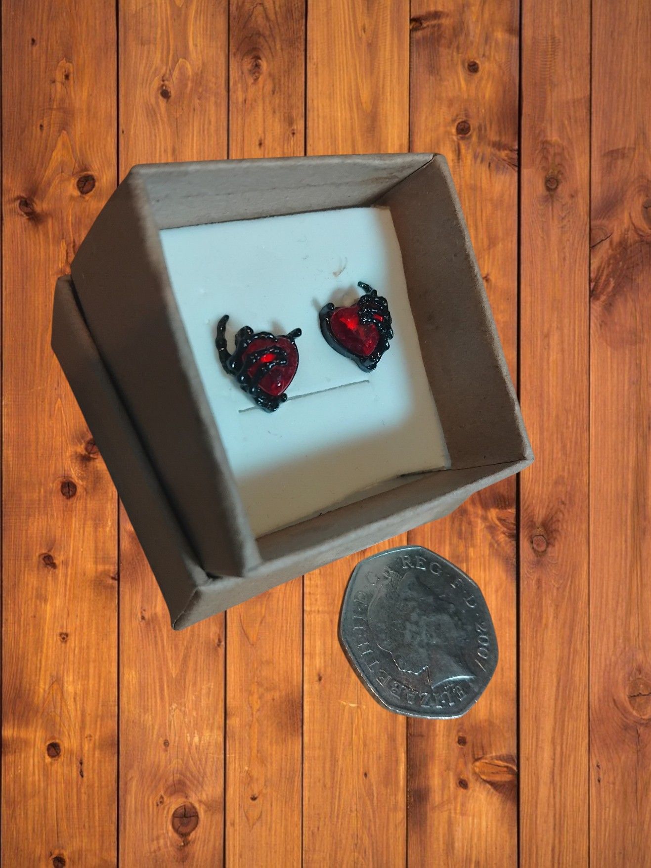(B-E-22) Pair of small heart in claw boxed earrings