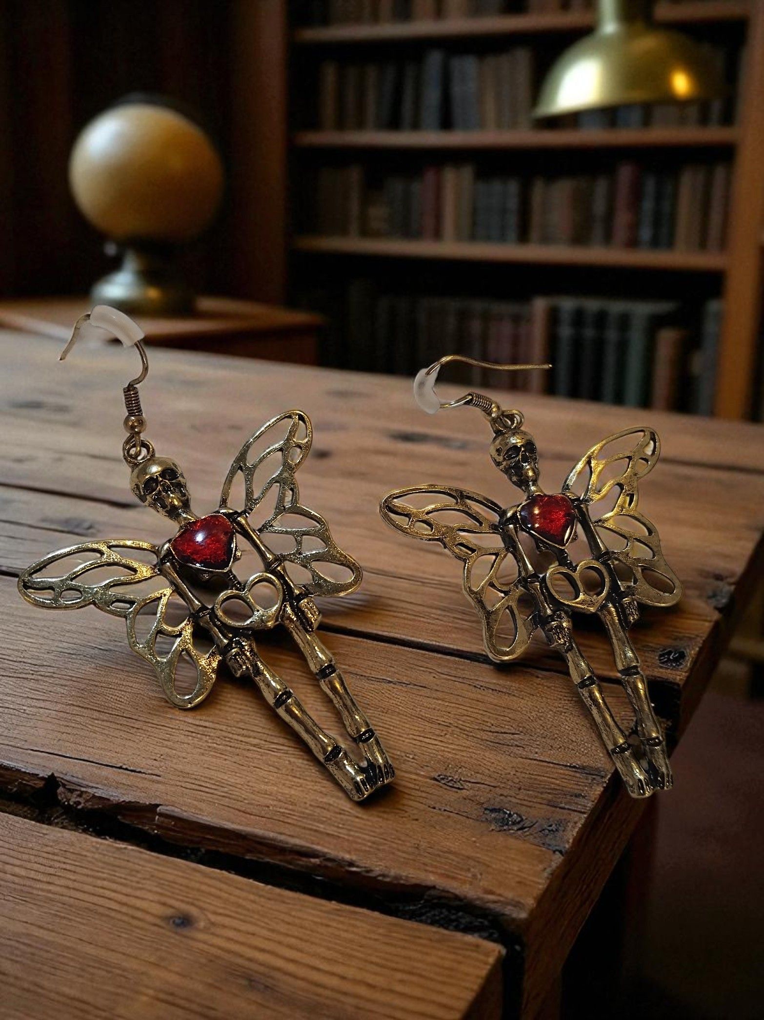 (E7) Winged skeleton with rhinestone heart boxed Earrings
