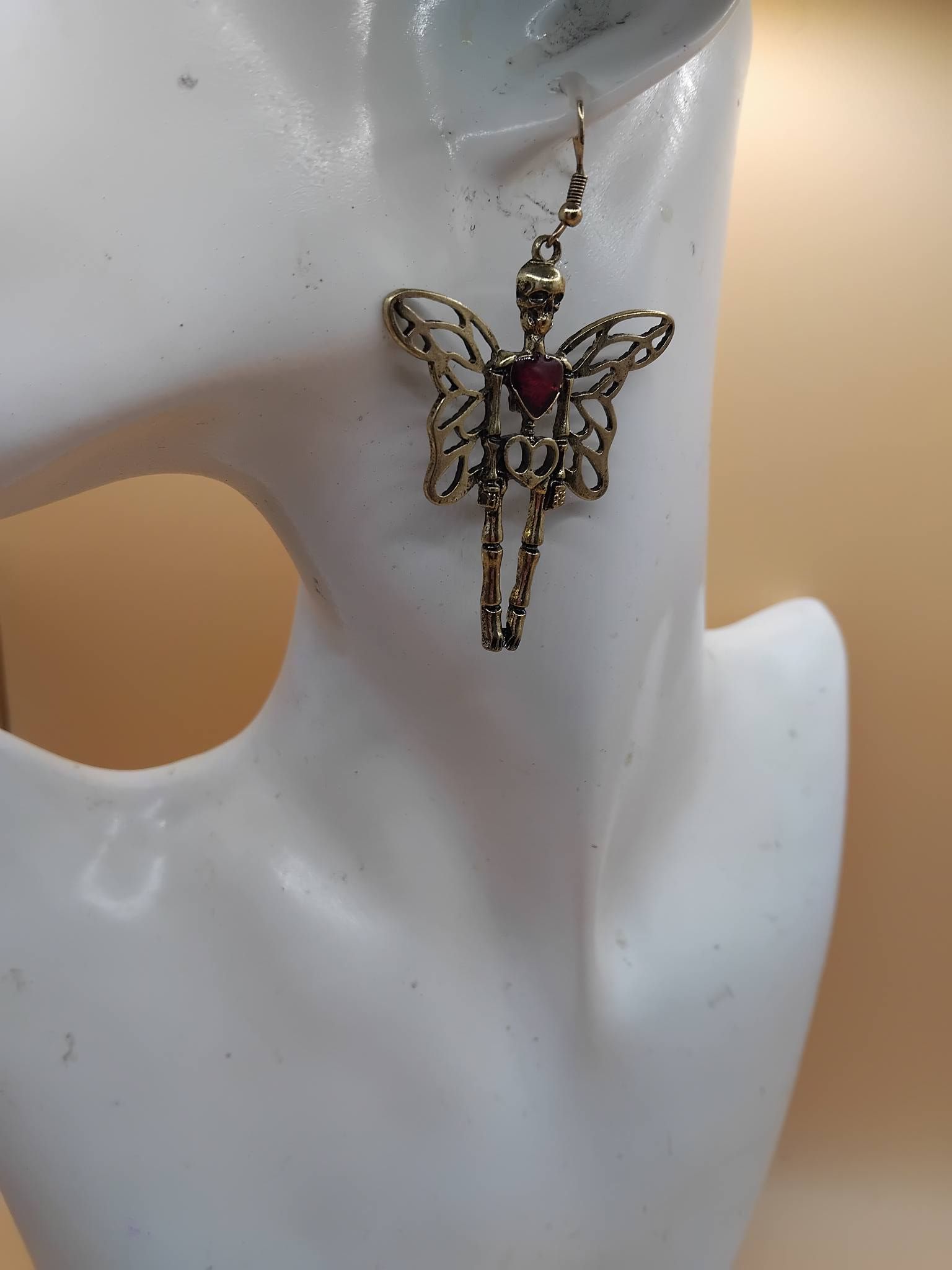 (E7) Winged skeleton with rhinestone heart boxed Earrings